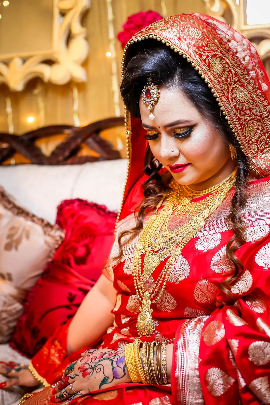 Bride in a red silk saree with gold jewellery