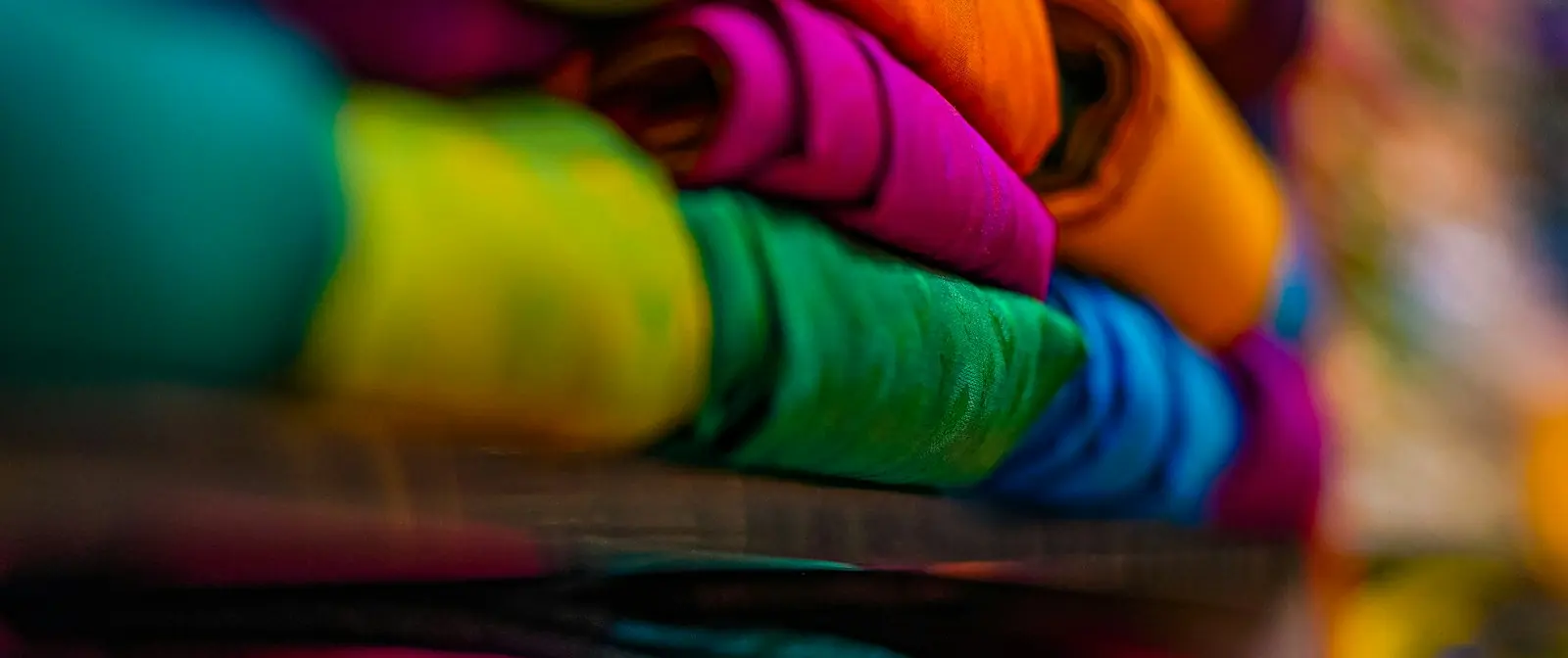 Shelves of folded silk sarees in every colour